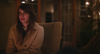 Movie still from “Palo Alto” (2013), directed by Gia Coppola – A woman sitting on top of a couch in a room; Close Up shot, Over the shoulder angle