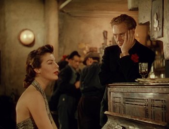 Movie still from “Pandora and the Flying Dutchman” (1951), directed by Albert Lewin – A man and a woman are sitting at a bar; Medium shot, Over the shoulder angle