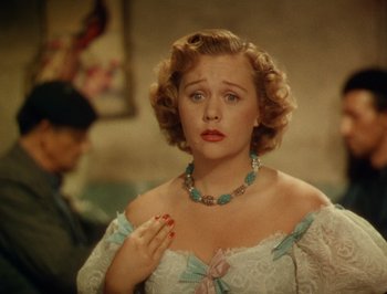 Movie still from “Pandora and the Flying Dutchman” (1951), directed by Albert Lewin – A woman in a white dress and a blue necklace; Close Up shot, Over the shoulder angle