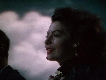 Movie still from “Pandora and the Flying Dutchman” (1951), directed by Albert Lewin – A beautiful woman with dark curly hair wearing a leather jacket; Close Up shot, Low angle