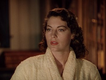 Movie still from “Pandora and the Flying Dutchman” (1951), directed by Albert Lewin – A woman in a robe looking at the camera; Close Up shot, Over the shoulder angle
