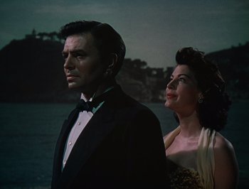 Movie still from “Pandora and the Flying Dutchman” (1951), directed by Albert Lewin – A man and a woman standing next to each other in front of a body of water; Medium shot, Low angle