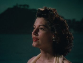 Movie still from “Pandora and the Flying Dutchman” (1951), directed by Albert Lewin – A beautiful woman with curly brown hair wearing a white dress; Close Up shot, Low angle
