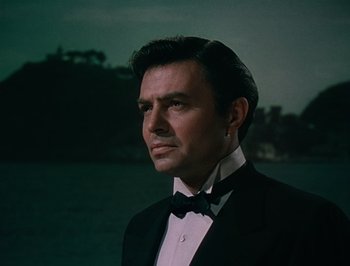Movie still from “Pandora and the Flying Dutchman” (1951), directed by Albert Lewin – A man in a tuxedo standing next to a body of water; Close Up shot, Low angle