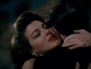 Movie still from “Pandora and the Flying Dutchman” (1951), directed by Albert Lewin – A woman in a black dress is hugging a man; Close Up shot, Overhead angle