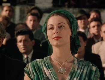 Movie still from “Pandora and the Flying Dutchman” (1951), directed by Albert Lewin – A woman with a green head scarf and a necklace; Close Up shot, Low angle