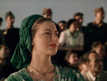 Movie still from “Pandora and the Flying Dutchman” (1951), directed by Albert Lewin – A woman with a green head scarf is looking to the side; Close Up shot, Low angle