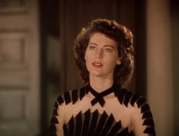 Movie still from “Pandora and the Flying Dutchman” (1951), directed by Albert Lewin – A woman in a black and white dress looking to her left; Close Up shot, Low angle