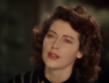 Movie still from “Pandora and the Flying Dutchman” (1951), directed by Albert Lewin – A person with curly hair; Close Up shot, Over the shoulder angle