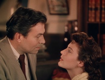 Movie still from “Pandora and the Flying Dutchman” (1951), directed by Albert Lewin – A man and a woman looking at each other in a room; Close Up shot, High angle