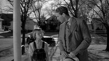 Movie still from “Paper Moon” (1973), directed by Peter Bogdanovich – An old photo of a man and a young boy talking to each other; Medium shot, Over the shoulder angle