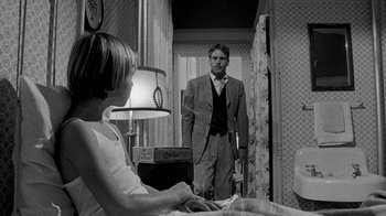 Movie still from “Paper Moon” (1973), directed by Peter Bogdanovich – A man and a woman standing in front of each other in a room; Medium shot, Over the shoulder angle