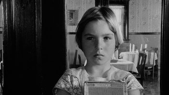 Movie still from “Paper Moon” (1973), directed by Peter Bogdanovich – A young girl is holding up an old radio; Close Up shot, Over the shoulder angle