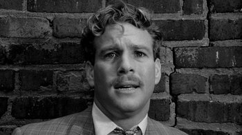 Movie still from “Paper Moon” (1973), directed by Peter Bogdanovich – Black and white photograph of a man in a suit; Close Up shot, Low angle