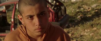 Movie still from “Paradise Now” (2005), directed by Hany Abu-Assad – A young man is looking into the distance; Close Up shot, Low angle