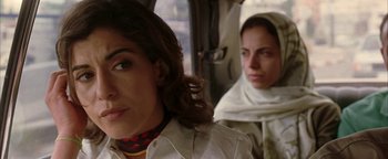 Movie still from “Paradise Now” (2005), directed by Hany Abu-Assad – Two women sitting in a car looking at the camera; Close Up shot, Over the shoulder angle