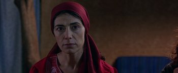 Movie still from “Paradise Now” (2005), directed by Hany Abu-Assad – A person wearing a head scarf; Close Up shot, Low angle