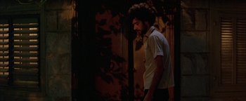 Movie still from “Paradise Now” (2005), directed by Hany Abu-Assad – A man standing in front of a door; Medium shot, Low angle