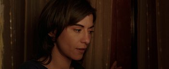 Movie still from “Paradise Now” (2005), directed by Hany Abu-Assad – A woman's face in front of a curtain; Close Up shot, High angle