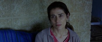 Movie still from “Paradise Now” (2005), directed by Hany Abu-Assad – A person sitting on a chair; Close Up shot, High angle