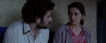 Movie still from “Paradise Now” (2005), directed by Hany Abu-Assad – A man and a woman sitting next to each other; Close Up shot, Over the shoulder angle