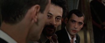 Movie still from “Paradise Now” (2005), directed by Hany Abu-Assad – A man with a beard is talking to two other men; Close Up shot, Over the shoulder angle