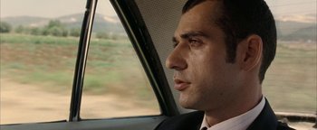 Movie still from “Paradise Now” (2005), directed by Hany Abu-Assad – A person sitting in a car looking out the window; Close Up shot, Over the shoulder angle