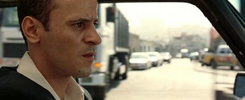 Movie still from “Paradise Now” (2005), directed by Hany Abu-Assad – A person driving a car on a street; Close Up shot, Low angle