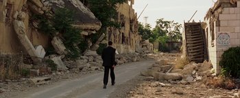 Movie still from “Paradise Now” (2005), directed by Hany Abu-Assad – A man in a suit is walking down the street; Extreme Wide shot, Over the shoulder angle