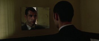 Movie still from “Paradise Now” (2005), directed by Hany Abu-Assad – A man looking at himself in a mirror; Close Up shot, Over the shoulder angle