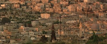 Movie still from “Paradise Now” (2005), directed by Hany Abu-Assad – An aerial view of a large city with many buildings; Extreme Wide shot, Low angle