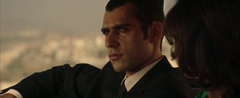 Movie still from “Paradise Now” (2005), directed by Hany Abu-Assad – A person wearing a suit and tie; Close Up shot, Over the shoulder angle
