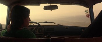 Movie still from “Paradise Now” (2005), directed by Hany Abu-Assad – A person in a car with the sun shining through the windshield; Medium shot, Over the shoulder angle