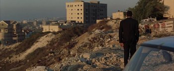 Movie still from “Paradise Now” (2005), directed by Hany Abu-Assad – A man standing on top of a rocky hill; Wide shot, Low angle