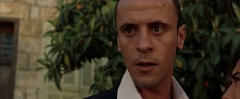 Movie still from “Paradise Now” (2005), directed by Hany Abu-Assad – A man's face in front of some trees; Close Up shot, Low angle