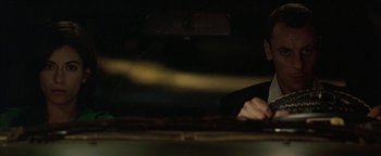 Movie still from “Paradise Now” (2005), directed by Hany Abu-Assad – A person playing a drum set in a dark room; Close Up shot, Over the shoulder angle