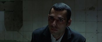 Movie still from “Paradise Now” (2005), directed by Hany Abu-Assad – A person wearing a suit and tie; Close Up shot, High angle