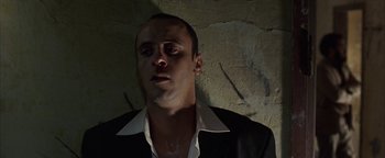 Movie still from “Paradise Now” (2005), directed by Hany Abu-Assad – A person wearing a suit and tie; Close Up shot, Low angle