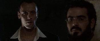 Movie still from “Paradise Now” (2005), directed by Hany Abu-Assad – A man in a suit and tie standing next to another man in a suit; Close Up shot, Low angle