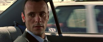 Movie still from “Paradise Now” (2005), directed by Hany Abu-Assad – A person wearing a suit and tie; Close Up shot, Over the shoulder angle