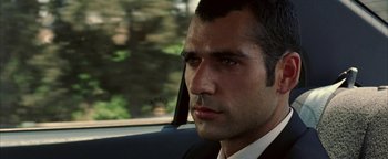 Movie still from “Paradise Now” (2005), directed by Hany Abu-Assad – A person wearing a suit in a car; Close Up shot, Over the shoulder angle
