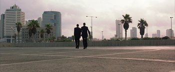 Movie still from “Paradise Now” (2005), directed by Hany Abu-Assad – A couple of men walking down a street; Extreme Wide shot, Low angle