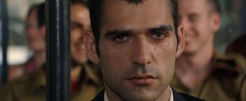 Movie still from “Paradise Now” (2005), directed by Hany Abu-Assad – A man's face in a suit and tie; Close Up shot, Over the shoulder angle