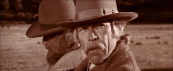 Movie still from “Pat Garrett & Billy the Kid” (1973), directed by Sam Peckinpah – An old man with a beard wearing a hat; Close Up shot, Low angle