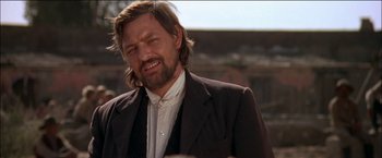 Movie still from “Pat Garrett & Billy the Kid” (1973), directed by Sam Peckinpah – A person wearing a suit and tie; Close Up shot, Low angle