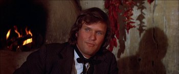 Movie still from “Pat Garrett & Billy the Kid” (1973), directed by Sam Peckinpah – A person with long hair wearing a suit; Close Up shot, Low angle