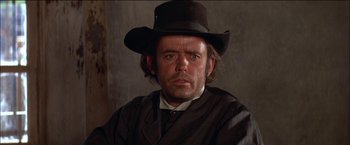 Movie still from “Pat Garrett & Billy the Kid” (1973), directed by Sam Peckinpah – A person wearing a hat; Close Up shot, Low angle