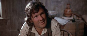 Movie still from “Pat Garrett & Billy the Kid” (1973), directed by Sam Peckinpah – A person wearing a shirt and tie; Close Up shot, Over the shoulder angle