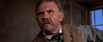 Movie still from “Pat Garrett & Billy the Kid” (1973), directed by Sam Peckinpah – An old man with a beard and a mustache; Close Up shot, Low angle