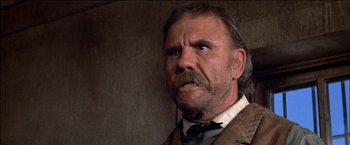 Movie still from “Pat Garrett & Billy the Kid” (1973), directed by Sam Peckinpah – An old man with a beard and a mustache; Close Up shot, Low angle